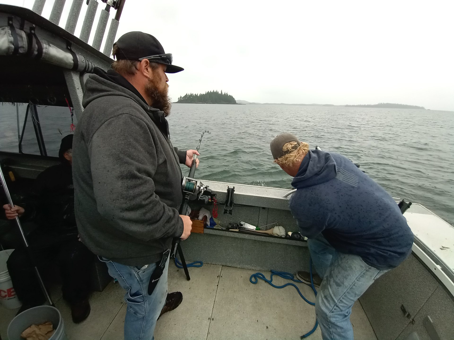 Guests fighting fish from the deck of a rental boat